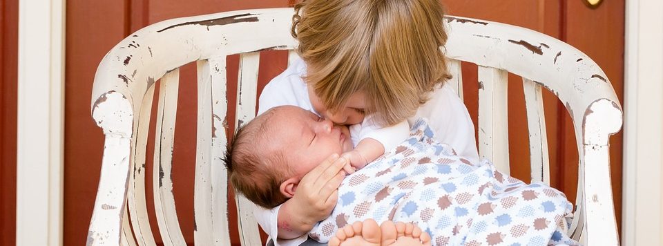 cute blonde kid with a baby